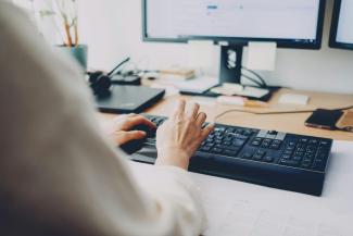 a person is typing on a computer keyboard by Daniel Enders-Theiss courtesy of Unsplash.