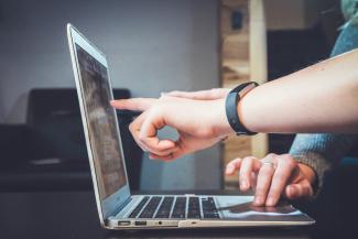 person using laptop by John Schnobrich courtesy of Unsplash.